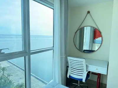 a mirror and a desk in a room with a window at Luxurious 1 Br Facing Manila Bay Sunset Nearby Okada MOA Solaire Ayala Malls in Manila