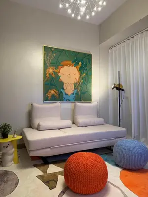a living room with a couch and a painting at Luxurious 1 Br Facing Manila Bay Sunset Nearby Okada MOA Solaire Ayala Malls in Manila