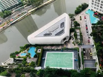 an overhead view of a building with a tennis court at Aveline Suites Luna,1br, Rockwell side in Manila