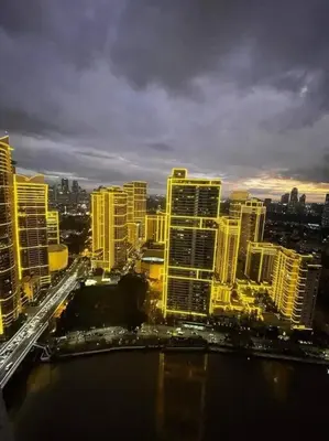 a view of a city at night with buildings at Aveline Suites Luna,1br, Rockwell side in Manila