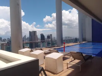 a swimming pool on the roof of a building at Aveline Suites Luna,1br, Rockwell side in Manila