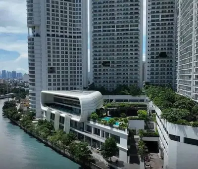 arial view of a building with trees in front of tall buildings at Aveline Suites Luna,1br, Rockwell side in Manila