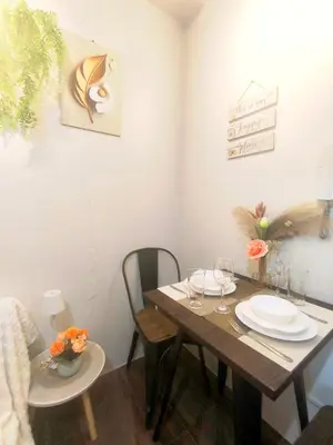 a dining room with a wooden table and chairs at Sun and Moon D'wood air residences makati in Manila