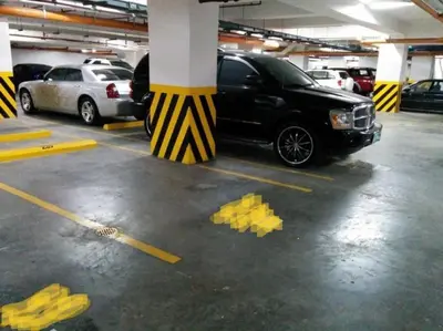 a parking lot with cars parked in a parking garage at SEA 2-BR Unit with Free Parking near Mall of Asia in Manila
