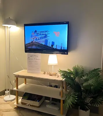 a flat screen tv on a wall in a living room at Casa Dona Suites at SMDC Charm Residences in Manila