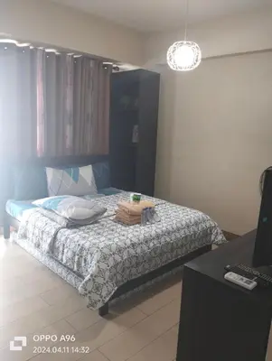 a bedroom with a bed with a plate on it at Two Palm Tree by Nadz in Manila