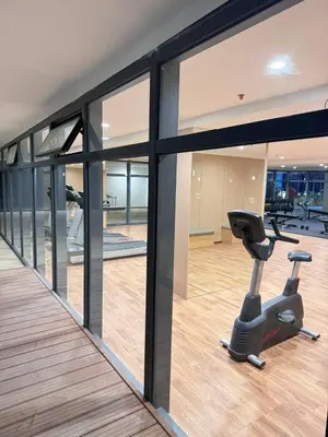 a gym with a treadmill and a exercise bike at Studio with Balcony Near Okada Manila and MOA LCONDOTEL in Manila