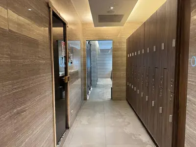 a hallway with wooden lockers in a locker room at Condo in Makati with Fast WiFi, Free Pool, Netflix and Own Balcony in Manila