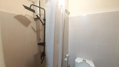 a bathroom with a shower curtain and a toilet at Mezza II Residences Condotel by Czarynah's Crib in Manila