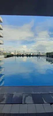 a large swimming pool with a view of a city at Mezza II Residences Condotel by Czarynah's Crib in Manila