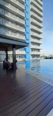a large building with a deck next to a body of water at Mezza II Residences Condotel by Czarynah's Crib in Manila