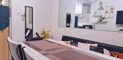 a restaurant with a table and a mirror at Mezza II Residences Condotel by Czarynah's Crib in Manila