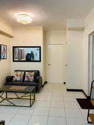 a living room with a couch and a table at Hello condo in Manila