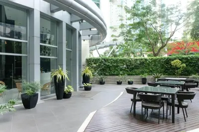 a patio with tables and chairs in a building at Jane in the City! In Avant, BGC in Manila