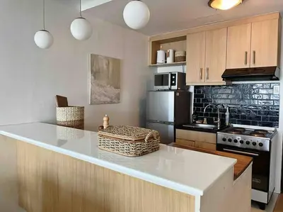 a kitchen with a white counter top and a stove at Solana in Avant BGC parking with fee in Manila
