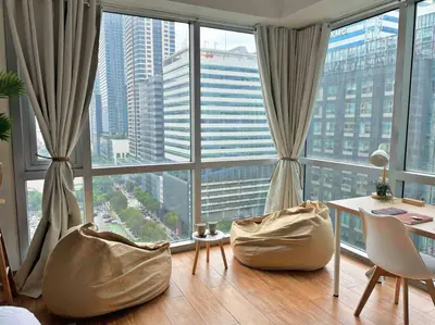 a room with a large window with a desk and chairs at Tarzan in the City! in Avant BGC parking with fee in Manila