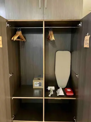a cupboard with a toaster and a appliance in it at Tarzan in the City! in Avant BGC parking with fee in Manila