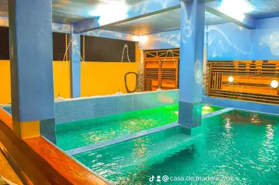 a swimming pool in a room with a water slide at Casa de Madera The Wooden House Staycation Transient and Private Resort in Cabuyao