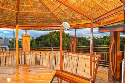 a wooden porch with a wooden table on a deck at Casa de Madera The Wooden House Staycation Transient and Private Resort in Cabuyao