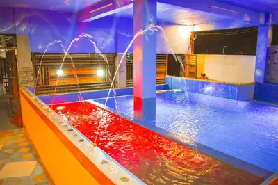 a pool with a water fountain in a room at Casa de Madera The Wooden House Staycation Transient and Private Resort in Cabuyao