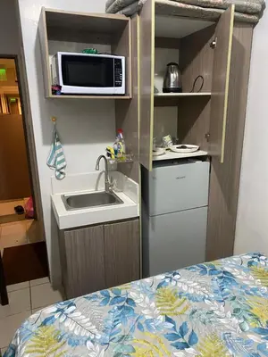 a small kitchen with a sink and a microwave at Pierrecondotel in Manila