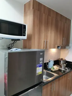 a kitchen with a microwave and a sink at Mall of Asia shore 3 residence in Manila