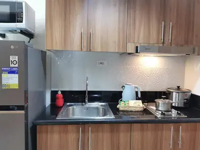 a kitchen with a sink and a microwave at Mall of Asia shore 3 residence in Manila