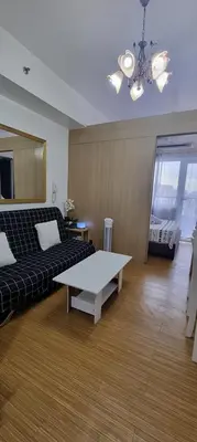 a living room with a couch and a coffee table at Suite 2253 in Manila