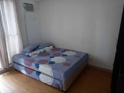 a bedroom with a bed with a polka dot blanket at Sorrel Residences- 2 Bedroom Apartment in Manila