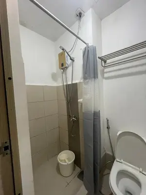 a bathroom with a shower and a toilet at Grace Residences Condo 1 BR Poolview near McKinley BGC in Manila