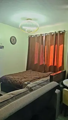 a bedroom with a bed with a curtain and a clock at HeRo's Lair - Staycation near EK with Ps4 & more! in Santa Rosa