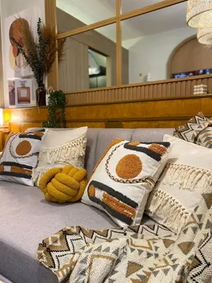 a bed with pillows and a stuffed animal on it at Cozy Vibes near MOA & NAIA AIRPORT with NETFLIX,MINIVIDEOKE,BOARDGAMES-DUXE3 in Manila
