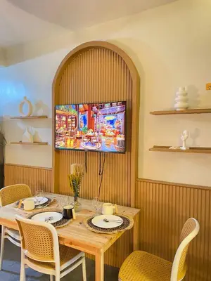 a dining room with a wooden table and chairs at Cozy Vibes near MOA & NAIA AIRPORT with NETFLIX,MINIVIDEOKE,BOARDGAMES-DUXE3 in Manila