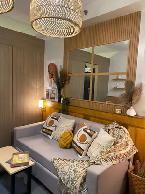 a living room with a couch and a mirror at Cozy Vibes near MOA & NAIA AIRPORT with NETFLIX,MINIVIDEOKE,BOARDGAMES-DUXE3 in Manila