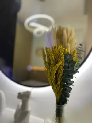 a vase with a brush in front of a mirror at Cozy Vibes near MOA & NAIA AIRPORT with NETFLIX,MINIVIDEOKE,BOARDGAMES-DUXE3 in Manila