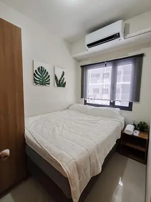 a small bedroom with a bed and a window at Haven of Tranquility Suite - SMDC Shore 3 (MOA) in Manila