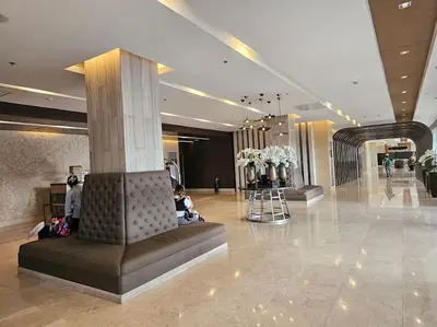 a lobby with a column in the middle of a building at Haven of Tranquility Suite - SMDC Shore 3 (MOA) in Manila