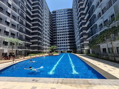 a swimming pool in the middle of a apartment complex at Haven of Tranquility Suite - SMDC Shore 3 (MOA) in Manila