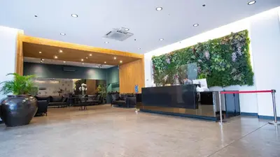 a lobby with a large plant on the wall at Green Sun Hotel in Manila