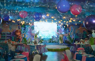 a birthday party with balloons and tables and a stage at Green Sun Hotel in Manila