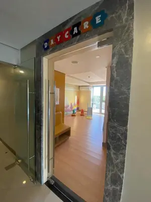 an entrance to a lobby with a sign on the wall at Suite by Xavie The Verdin by MAPLE Grove in General Trias
