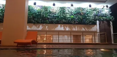 a chair sitting in a room with a pool of water at Suite by Xavie The Verdin by MAPLE Grove in General Trias