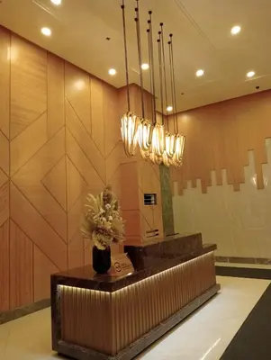 a lobby with a mirror and a vase of flowers at Suite by Xavie The Verdin by MAPLE Grove in General Trias