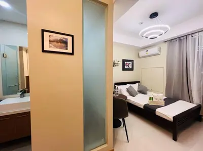 a small room with a bed and a bathroom at 1BR Condotel Suite at Sunshine100 City Plaza #SS06 in Manila