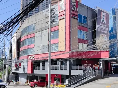 a building with a red car parked in front of it at 1BR Condotel Suite at Sunshine100 City Plaza #SS02 in Manila