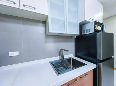 a kitchen with a sink and a black refrigerator at 1BR Condotel Suite at Sunshine100 City Plaza #SS02 in Manila