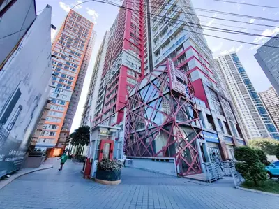 a building in the middle of a city with tall buildings at 1BR Condotel Suite at Sunshine100 City Plaza #SS02 in Manila