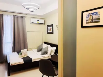a room with a bed and a table and a chair at 1BR Condotel Suite at Sunshine100 City Plaza #SS05 in Manila
