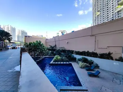 a swimming pool on the side of a building at 1BR Condotel Suite at Sunshine100 City Plaza #SS05 in Manila