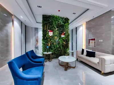 a living room with a blue chair and a couch at 1BR Condotel Suite at Sunshine100 City Plaza #SS03 in Manila